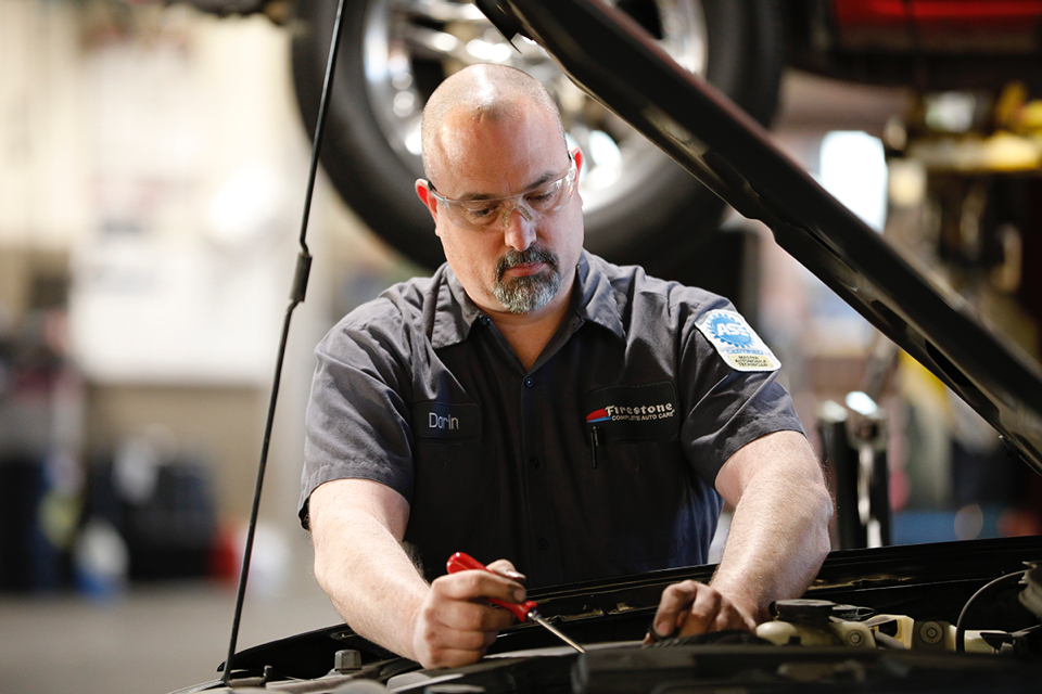 Darin Stalker working on car for Bridgestone Retail Operations